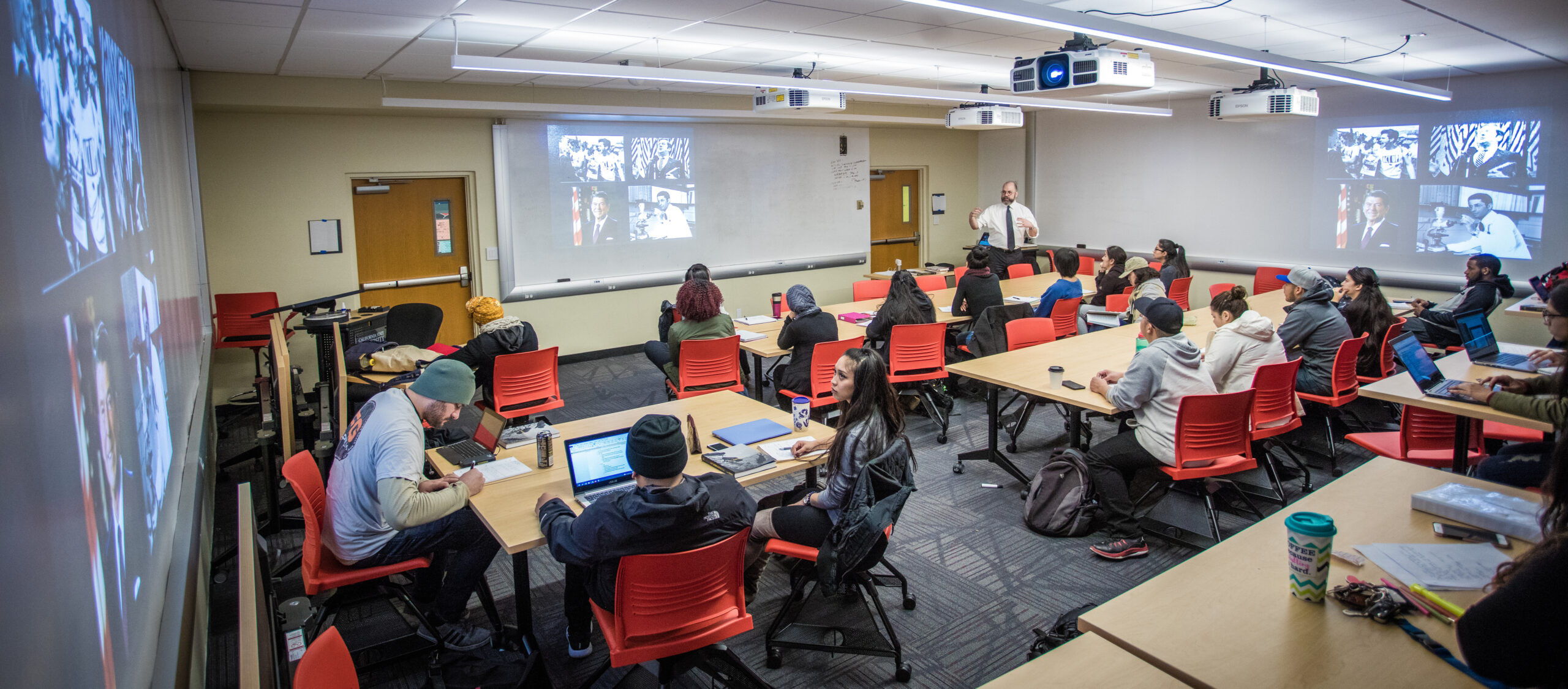 Students in a classroom looking at visual media