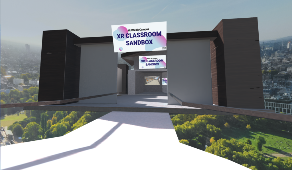Screenshot of entrance to classroom n the XR sandbox. A modern building is floating in an urban space with a concrete walkway. 