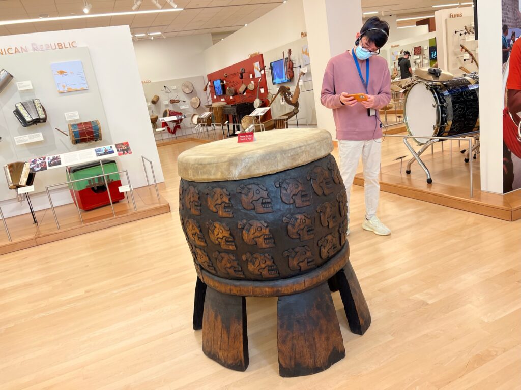 Anh Tran taking a photo of an ancient free-standing Mexican drum 