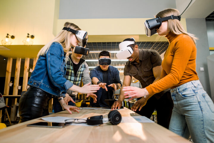 Young adults wearing VR headsets interacting with media
